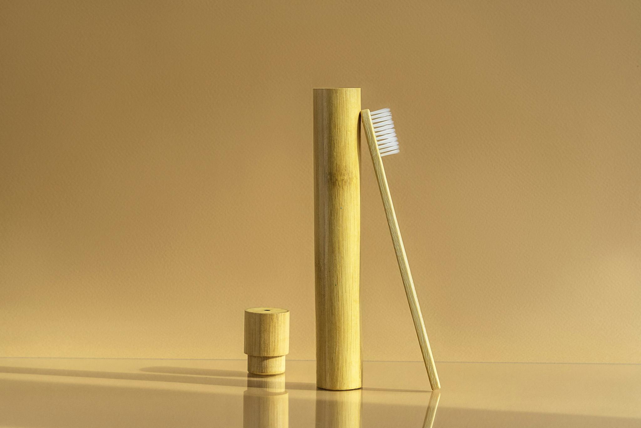 Services A Minimalist Bamboo Toothbrush Set Against A